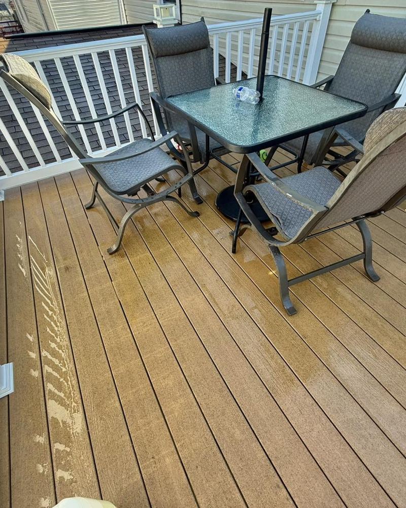 The same composite deck boards cleaned back to their original color after low-pressure washing