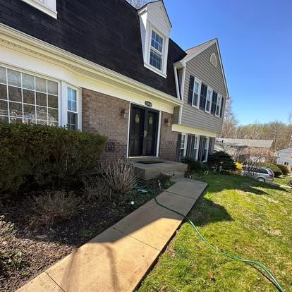 The same exterior concrete slab cleaned to an even light gray finish after surface cleaning