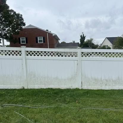 The same vinyl fence panel returned to a clean white finish after mold and algae removal